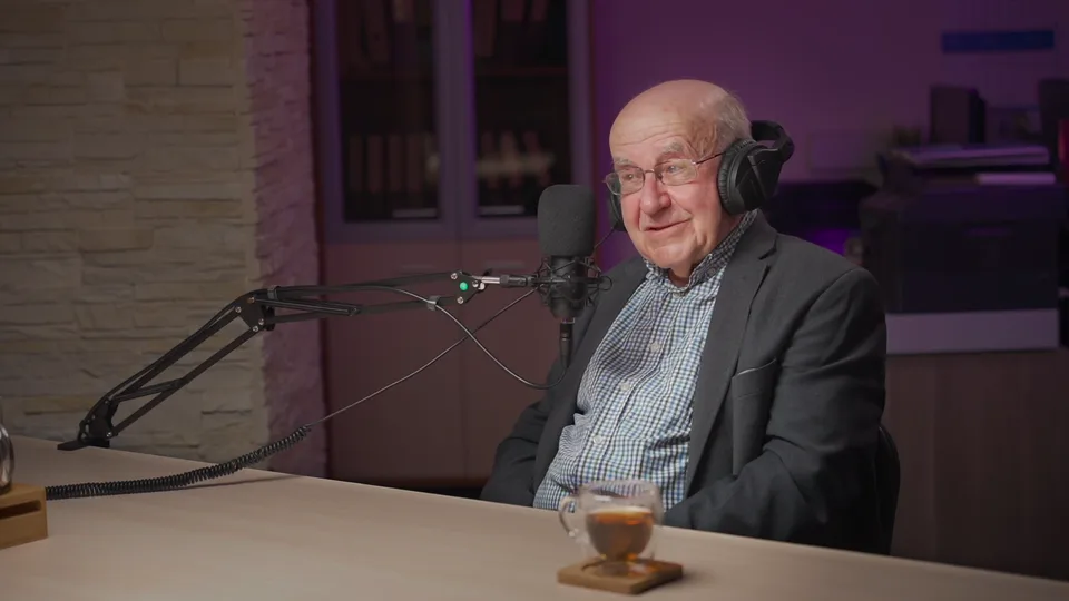 An older guest in a jacket smiling at the table, May 2021