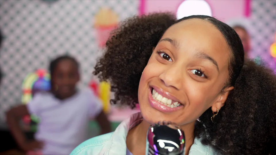 A close-up of the singer smiling straight into the lens